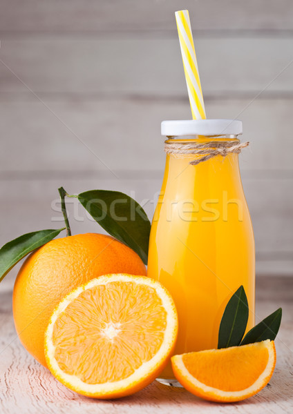 Glass bottle of raw organic fresh orange juice Stock photo © DenisMArt