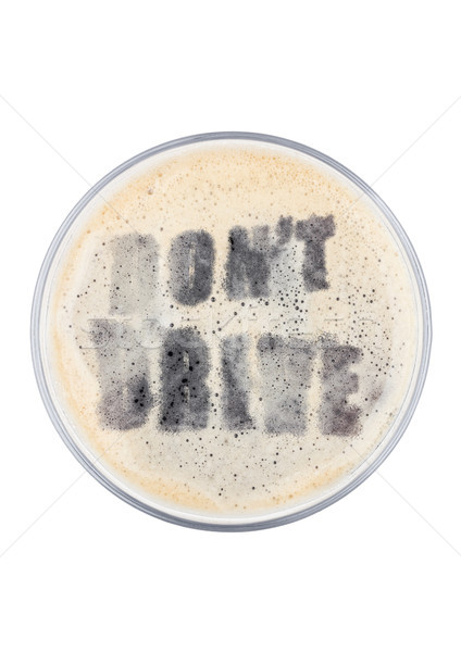 Glass of stout beer top with don't drive shape Stock photo © DenisMArt