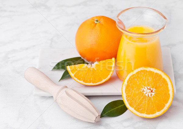 Fresh raw peeled oranges with hand juice squeezer  Stock photo © DenisMArt