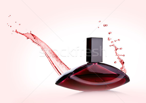 Lüks pembe sıvı parfüm şişe sıçraması Stok fotoğraf © DenisMArt