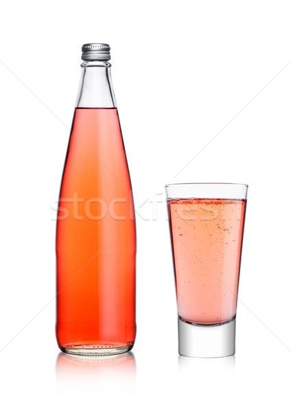 Bottle and glass of sparkling pink soda lemonade Stock photo © DenisMArt