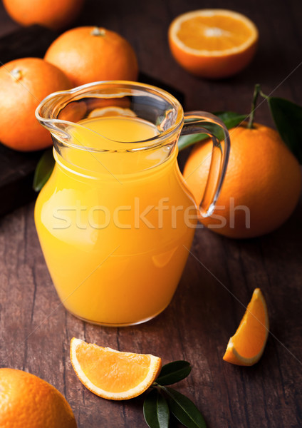 Glass jar of raw organic fresh orange juice on wood Stock photo © DenisMArt