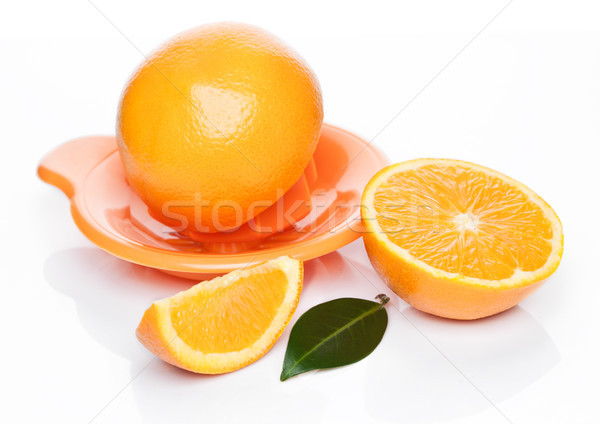 Stock photo: Fresh raw peeled oranges with juice squeezer 