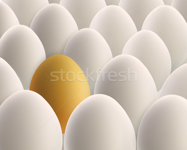 Stock photo: unique golden egg between white eggs