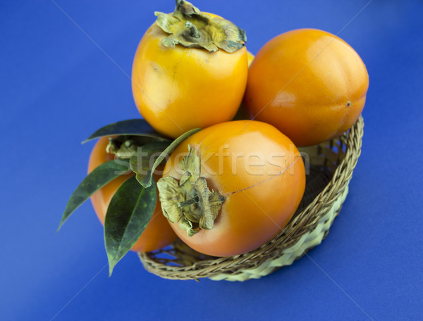 Persimmon vruchten geïsoleerd Blauw voedsel natuur Stockfoto © designsstock