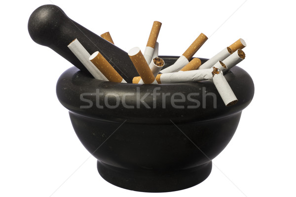 Quit smoking - pestle with cigarettes isolated over white Stock photo © devulderj