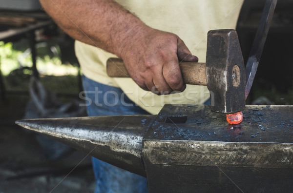 Blacksmith forges iron on anvil Stock photo © deyangeorgiev