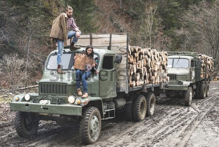 Young man on vintage truck with logs Stock photo © deyangeorgiev