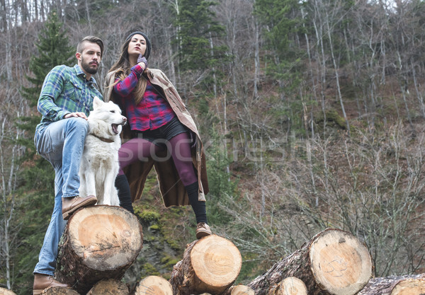 Young woman and men on wood logs Stock photo © deyangeorgiev