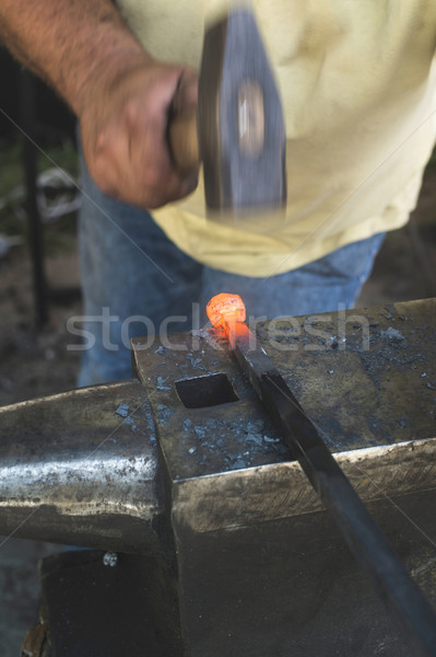 Blacksmith forges iron on anvil Stock photo © deyangeorgiev