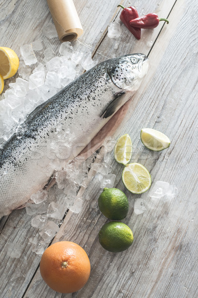 Raw salmon fish in ice and vegetables Stock photo © deyangeorgiev