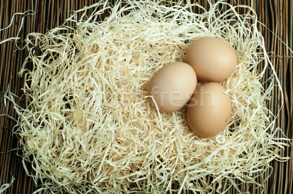 Raw eggs in straw Stock photo © deyangeorgiev