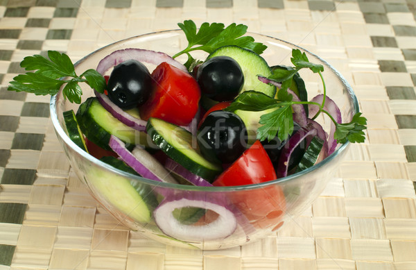 Salad in a glass bowl on a wooden base Stock photo © deyangeorgiev