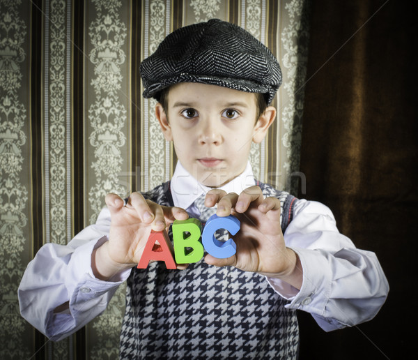 Stock photo: Child in vintage clothes hold letters a b c