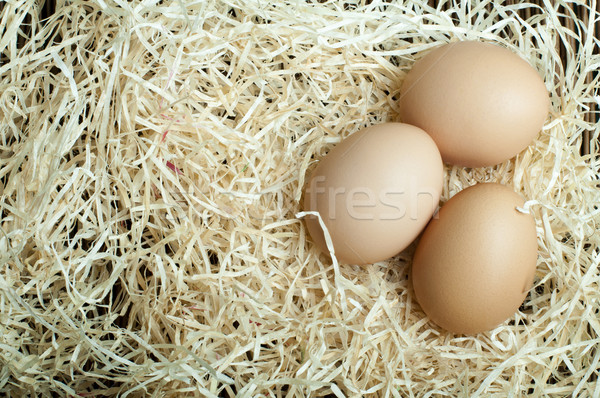 Сток-фото: сырой · яйца · соломы · три · яйцо · завтрак