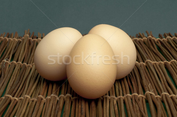 Raw eggs on wooden base Stock photo © deyangeorgiev