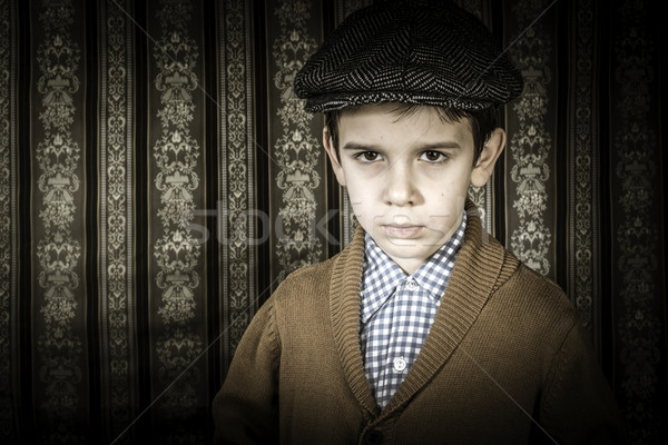 Frowning child in vintage clothes and hat Stock photo © deyangeorgiev