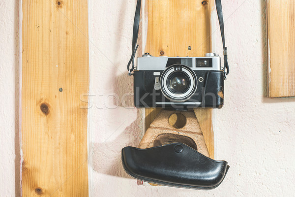 Vintage photo camera hooked on the wall Stock photo © deyangeorgiev