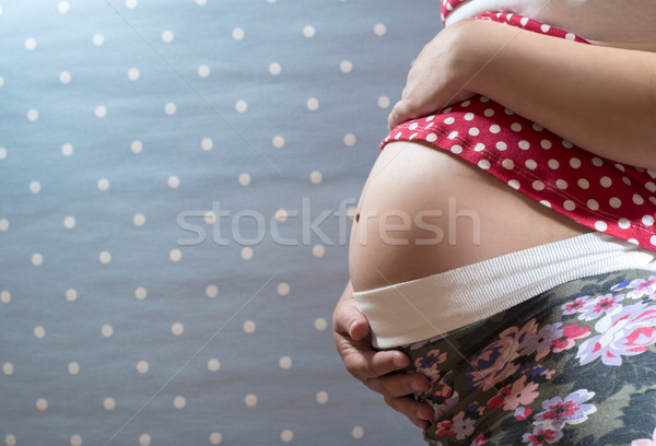 Pregnant woman shows his belly Stock photo © deyangeorgiev