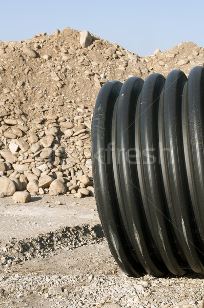 Pipes and piles of sand in the background Stock photo © deyangeorgiev