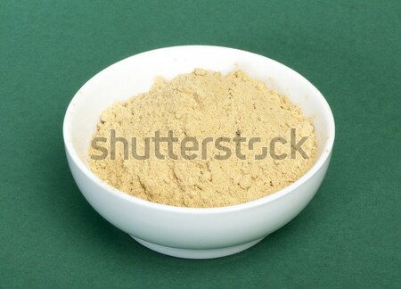 Powdered ginger in a bowl and whole ginger Stock photo © deyangeorgiev