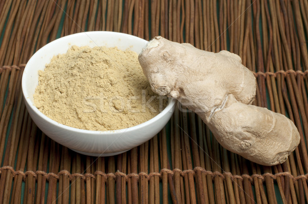 Powdered ginger in a bowl and whole ginger Stock photo © deyangeorgiev