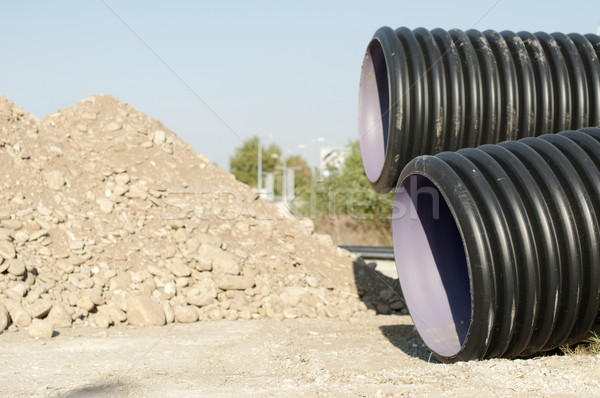 Pipes and piles of sand in the background Stock photo © deyangeorgiev