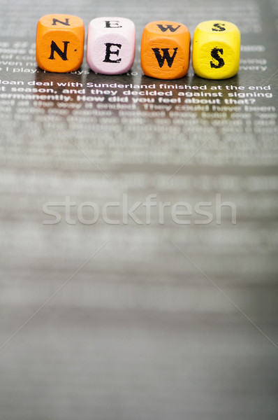 Word news.Wooden cubes on magazine Stock photo © deyangeorgiev