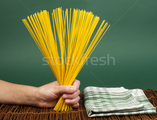 Female hand holding spaghetti Stock photo © deyangeorgiev