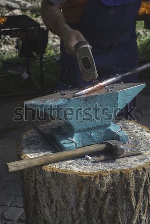 Blacksmith forges iron on anvil Stock photo © deyangeorgiev