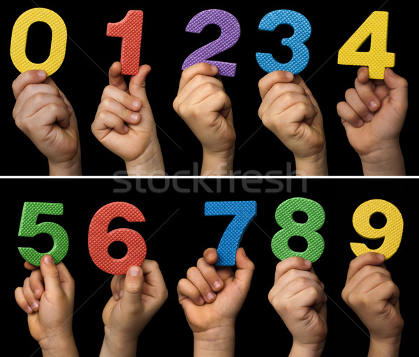 Children hands holding numbers. Black isolated multicolor number Stock photo © deyangeorgiev