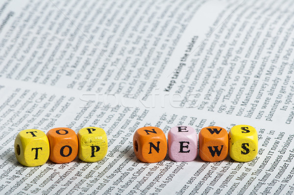 Word top news.Wooden cubes on magazine Stock photo © deyangeorgiev