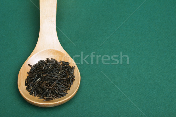 Wild black rice in wooden spoon Stock photo © deyangeorgiev