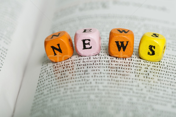 Word news.Wooden cubes on magazine Stock photo © deyangeorgiev