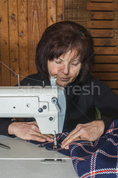 Woman sewing on a sewing machine Stock photo © deyangeorgiev