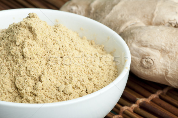 Powdered ginger in a bowl and whole ginger Stock photo © deyangeorgiev