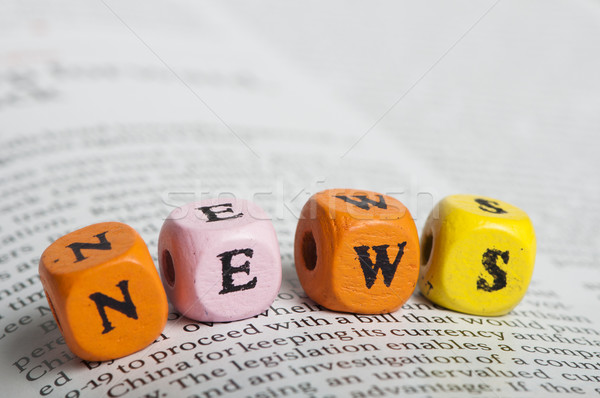 Word news.Wooden cubes on magazine Stock photo © deyangeorgiev