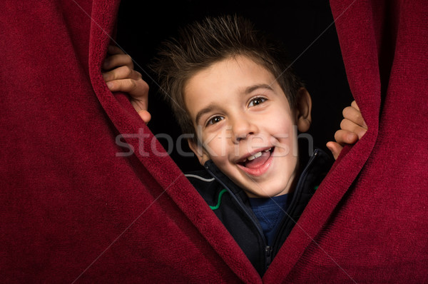 Child appearing beneath the curtain Stock photo © deyangeorgiev