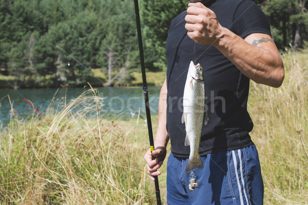 Fisherman caught a fish Stock photo © deyangeorgiev
