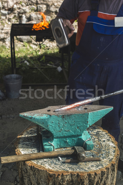 Blacksmith forges iron on anvil Stock photo © deyangeorgiev
