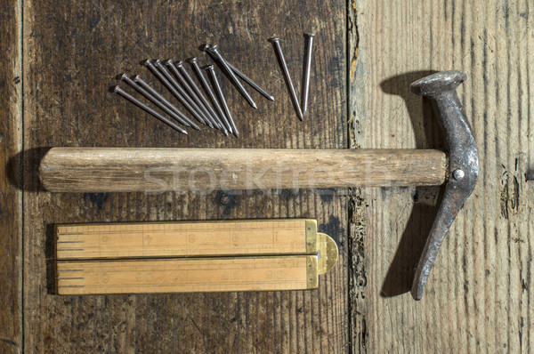 Vintage hammer, nails and wooden centimeter Stock photo © deyangeorgiev