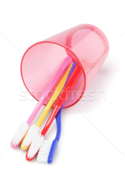 Colorful Toothbrushes In Plastic Cup Stock photo © dezign56