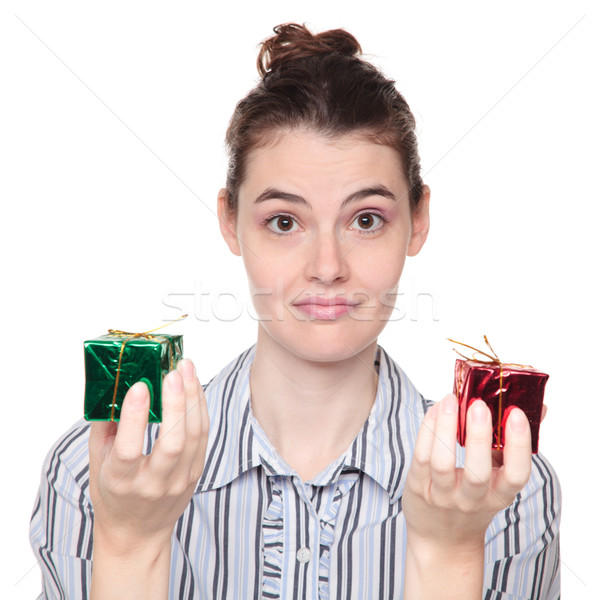 dark haired woman choosing between red and green Christmas prese Stock photo © dgilder