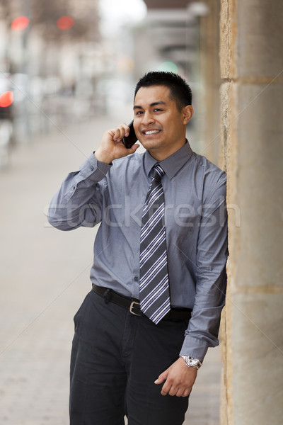 Hispanic Businessman - Leaning on Wall Stock photo © dgilder