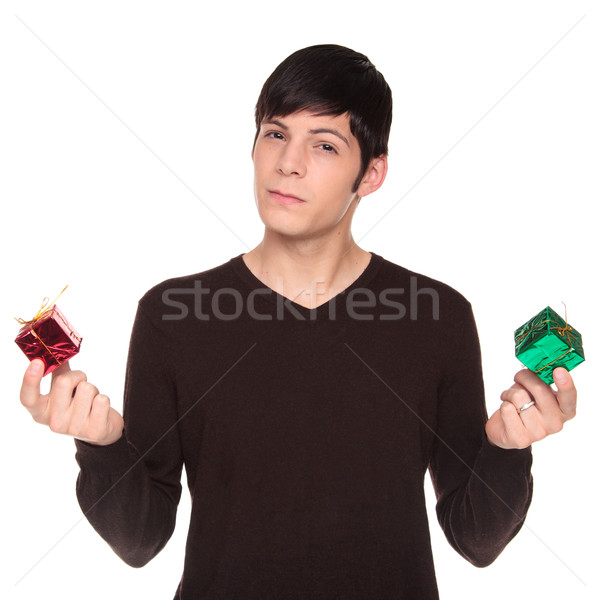 Caucasian man comparing green present to red Stock photo © dgilder