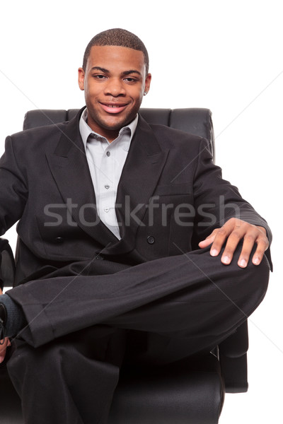Fiatal afroamerikai üzletember megnyugtató szék izolált Stock fotó © dgilder