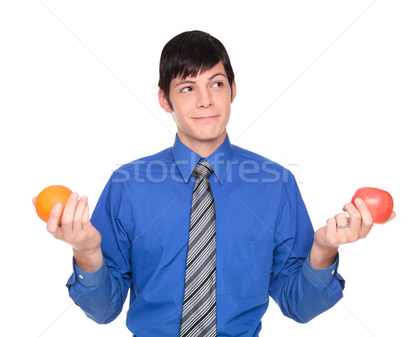 Caucasian businessman comparing apple to orange Stock photo © dgilder