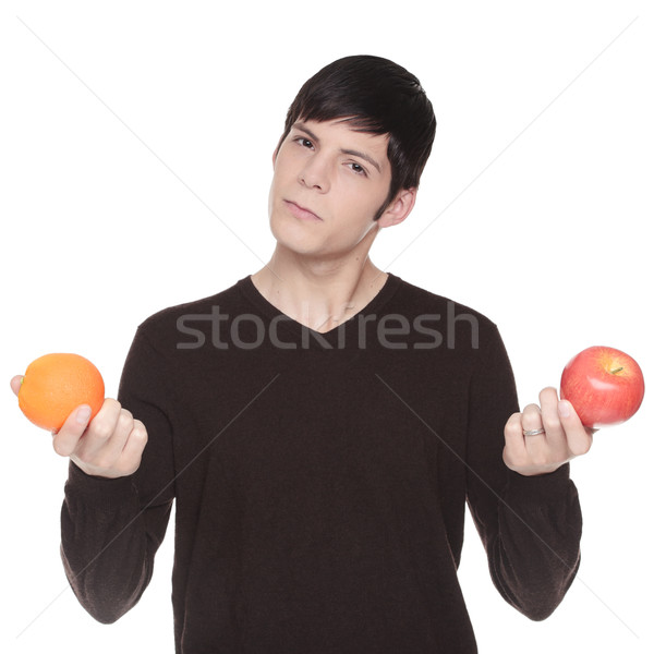 Caucasian man comparing apple to orange Stock photo © dgilder