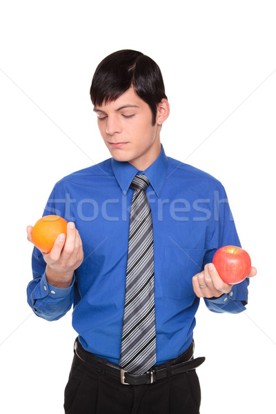Caucasian businessman comparing apple to orange Stock photo © dgilder