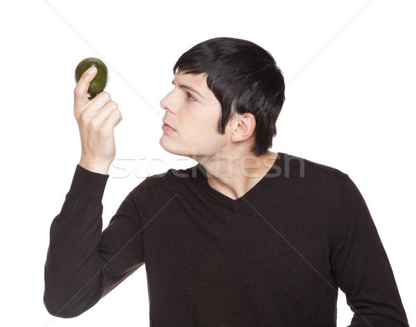 Caucasian man examining a lime Stock photo © dgilder